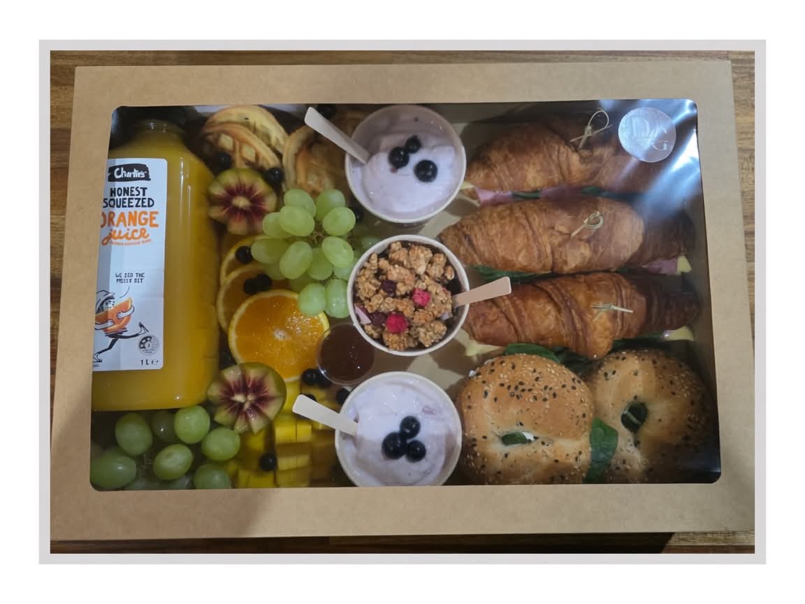 Breakfast grazing box with croissants, bagels, granola, yoghurt and fresh orange juice